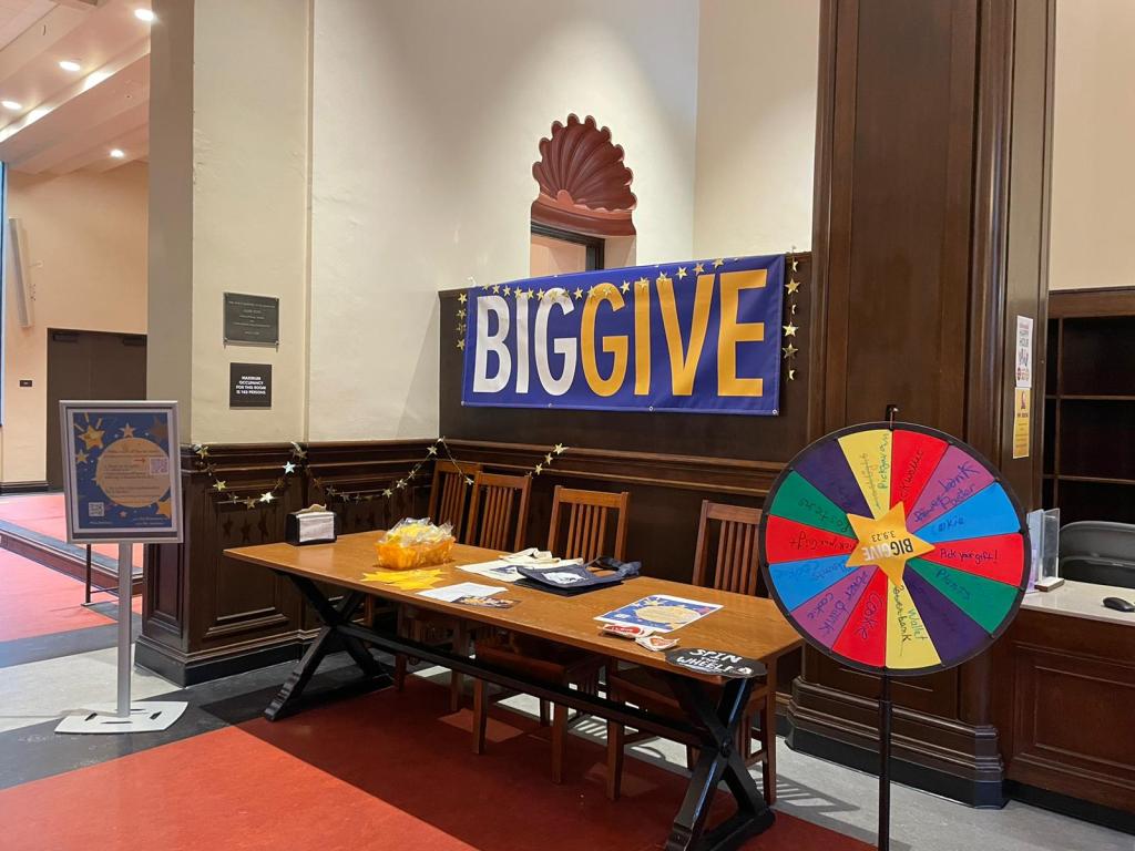 Photo of the Big Give table and Spin the Wheel in the Dining Commons