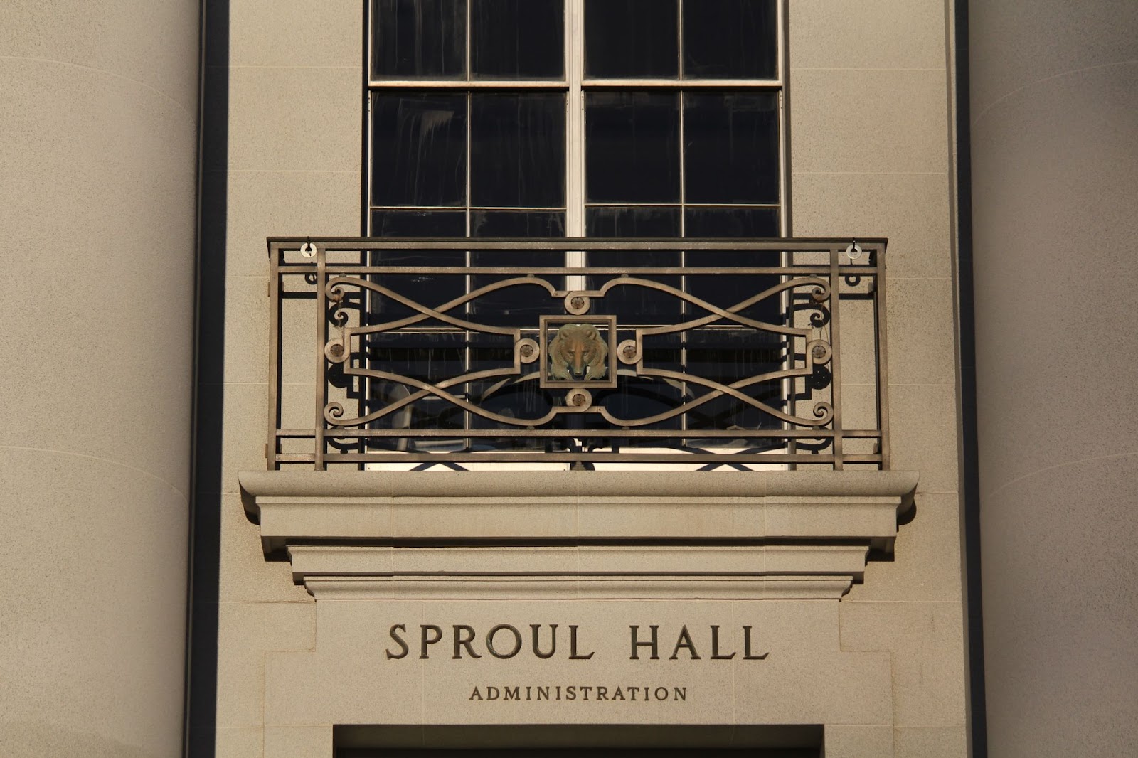 A balcony above Sproul Hall, with an ornate railing, which has a bear motif in the center. 
