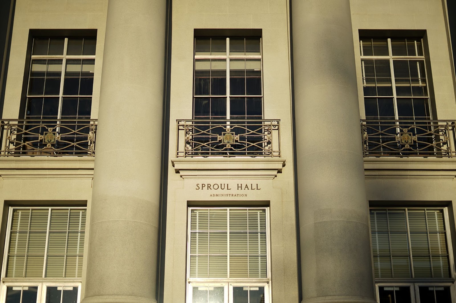 Three balconies above Sproul Hall, all with ornate railings, all of which have a bear motif in the center. 