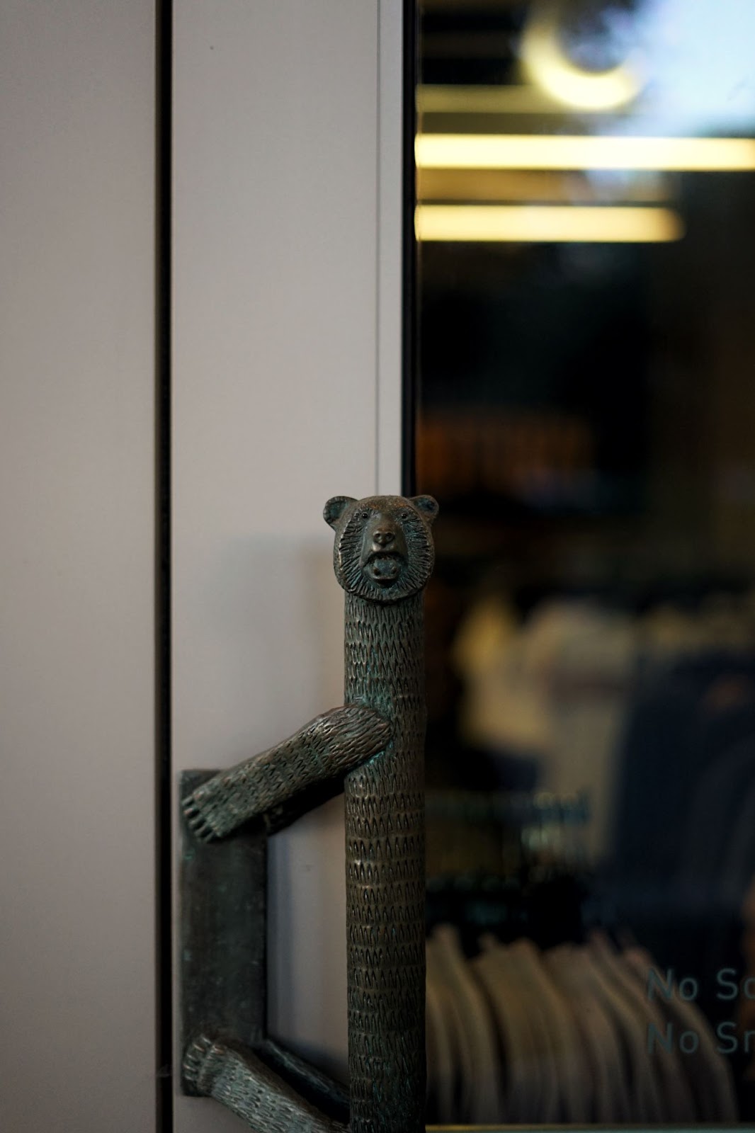 A door handle fashioned in the form of a bear. 