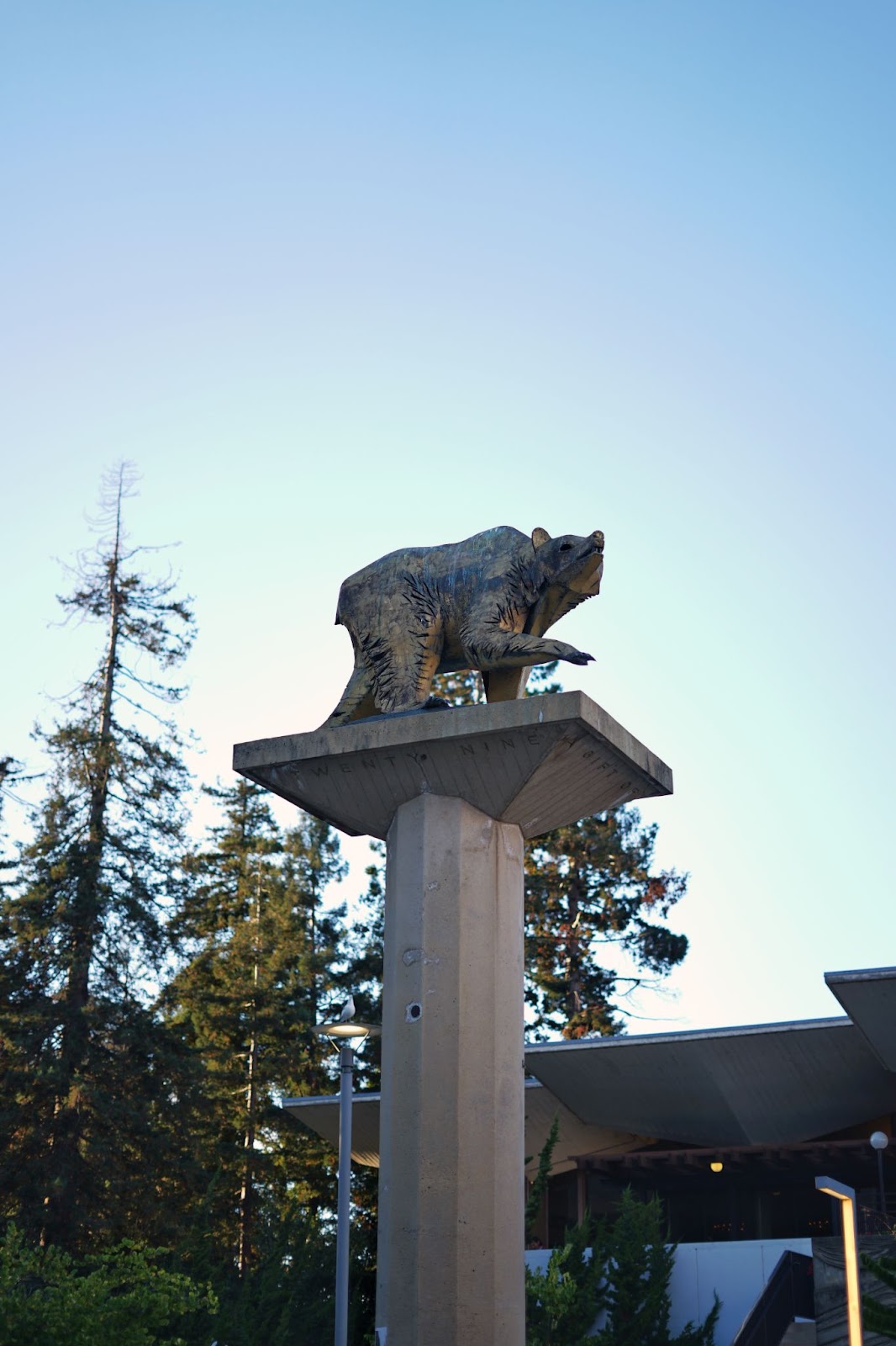 A statue of a bear walking atop a pillar. 