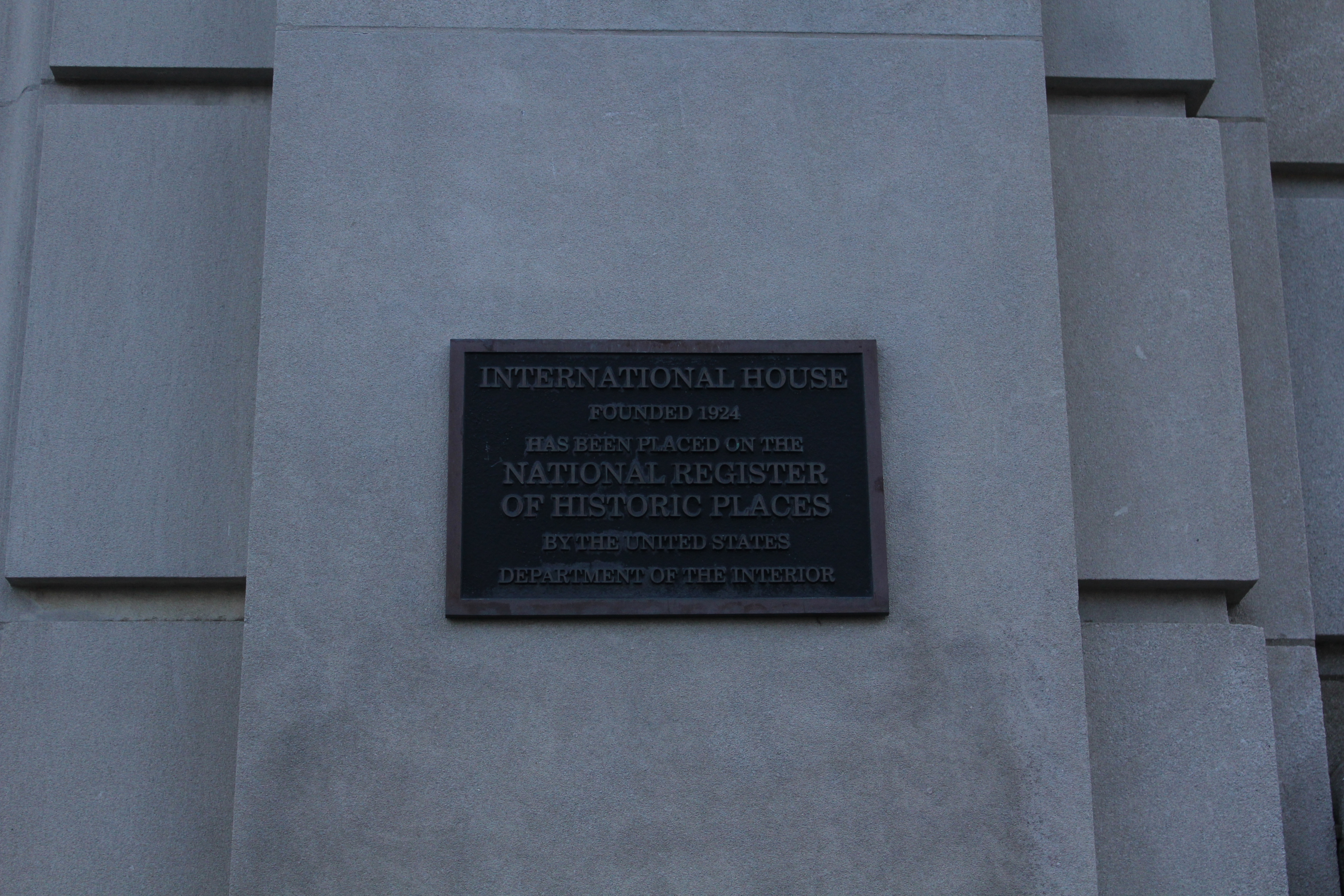 A Plaque reads "INTERNATIONAL HOUSE
FOUNDED 1924
HAS BEEN PLACED ON THE NATIONAL REGISTER 
OF HISTORIC PLACES
BY THE UNITED STATES
DEPARTMENT OF THE INTERIOR"