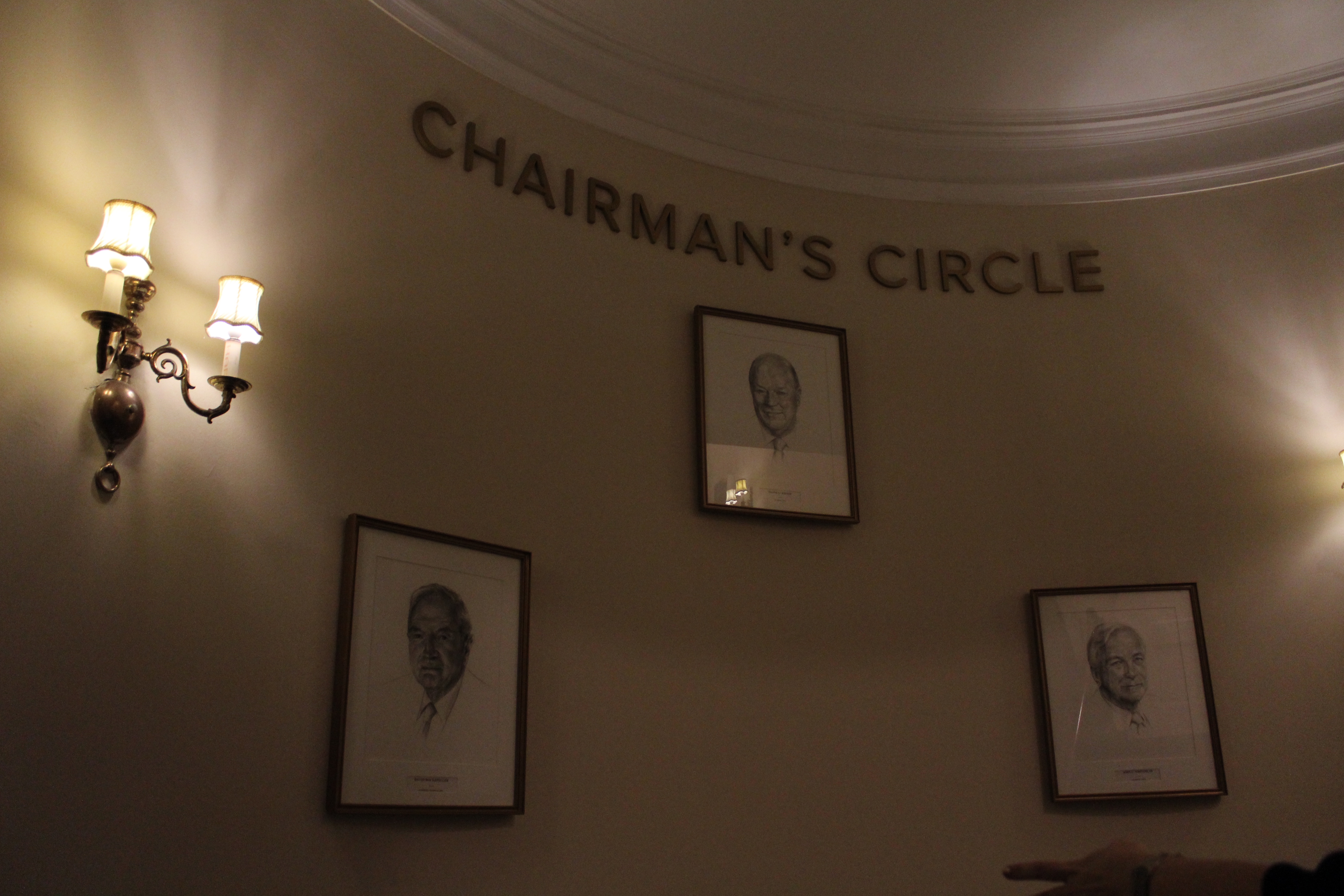 A sign reads "Chairman's Circle" with three portraits under it. 