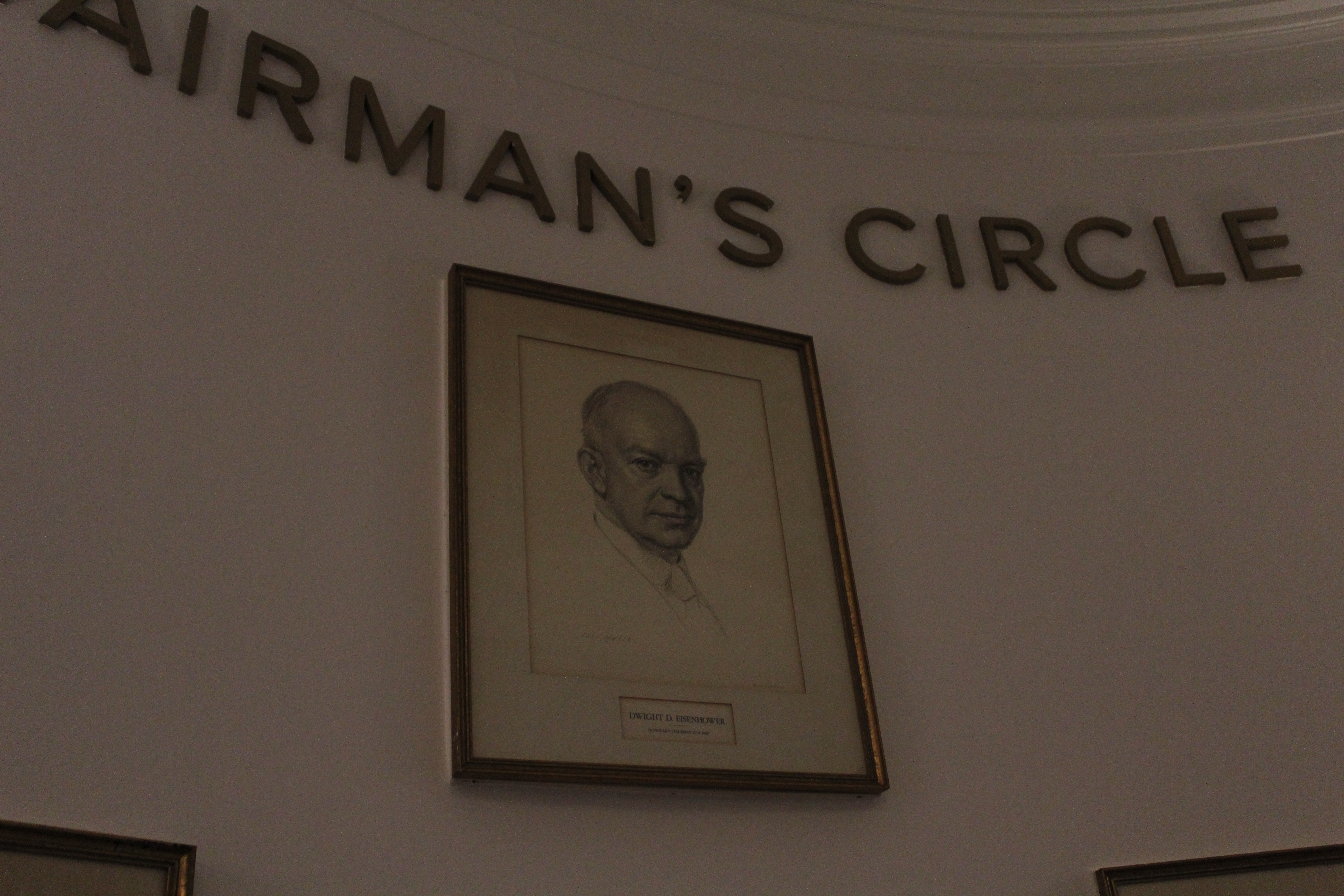 A portrait of Dwight Eisenhower under a sign of "Chairman's Circle"