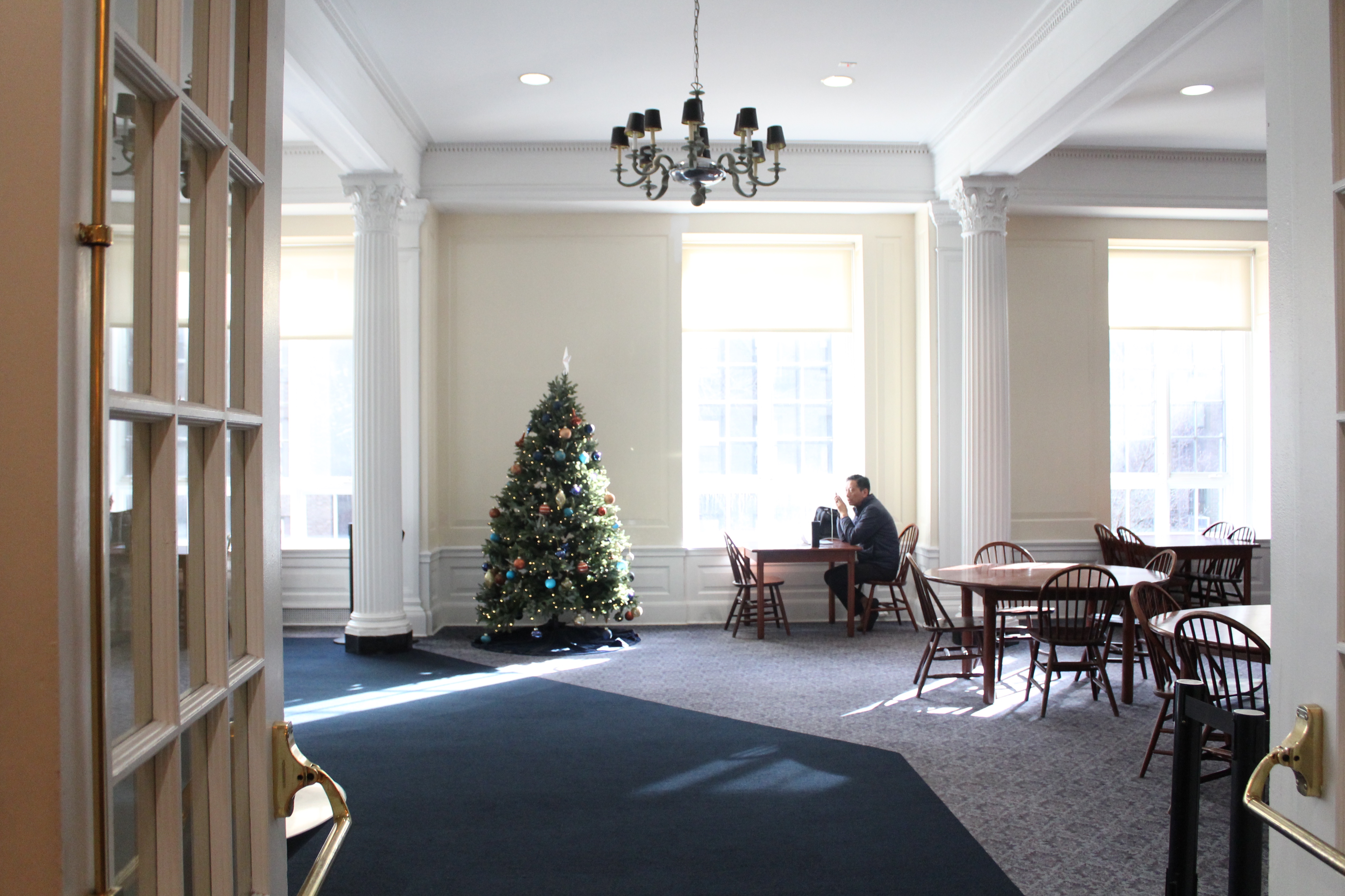 A dining lobby with a Christmas tree.